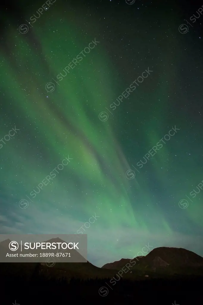 The Aurora Borealis Or Northern Lights Shine In The Night Sky Over The Landscape;Yukon Canada