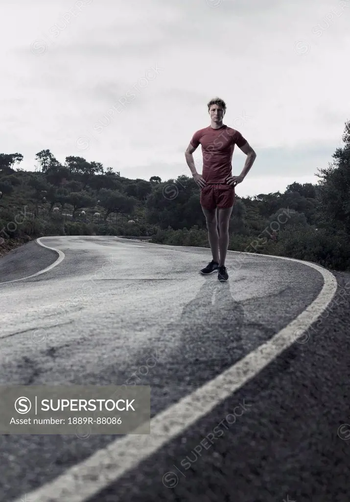 A Young Man In Running Shorts And T-Shirt Posing On A Road;Tarifa Cadiz Andalusia Spain