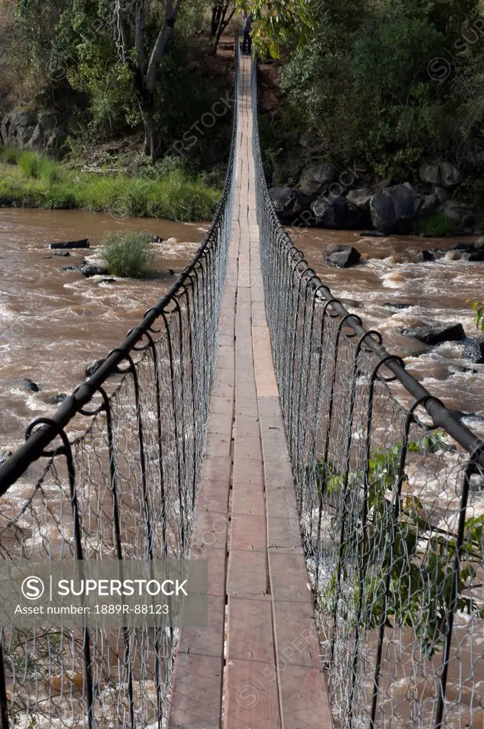 A Long Suspension Bridge Over A River In The Maasai Mara National Reserve;Maasai Mara Kenya