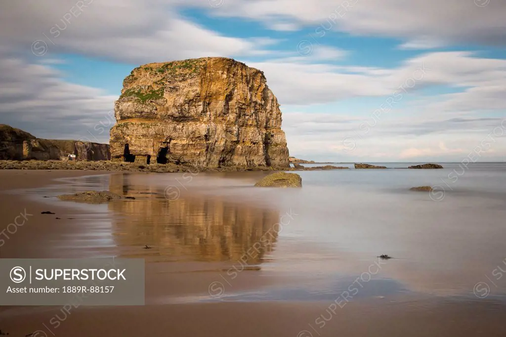 A Large Rock Formation Reflected In The Wet Sand On A Beach On The Coast;South Shields Tyne And Wear England