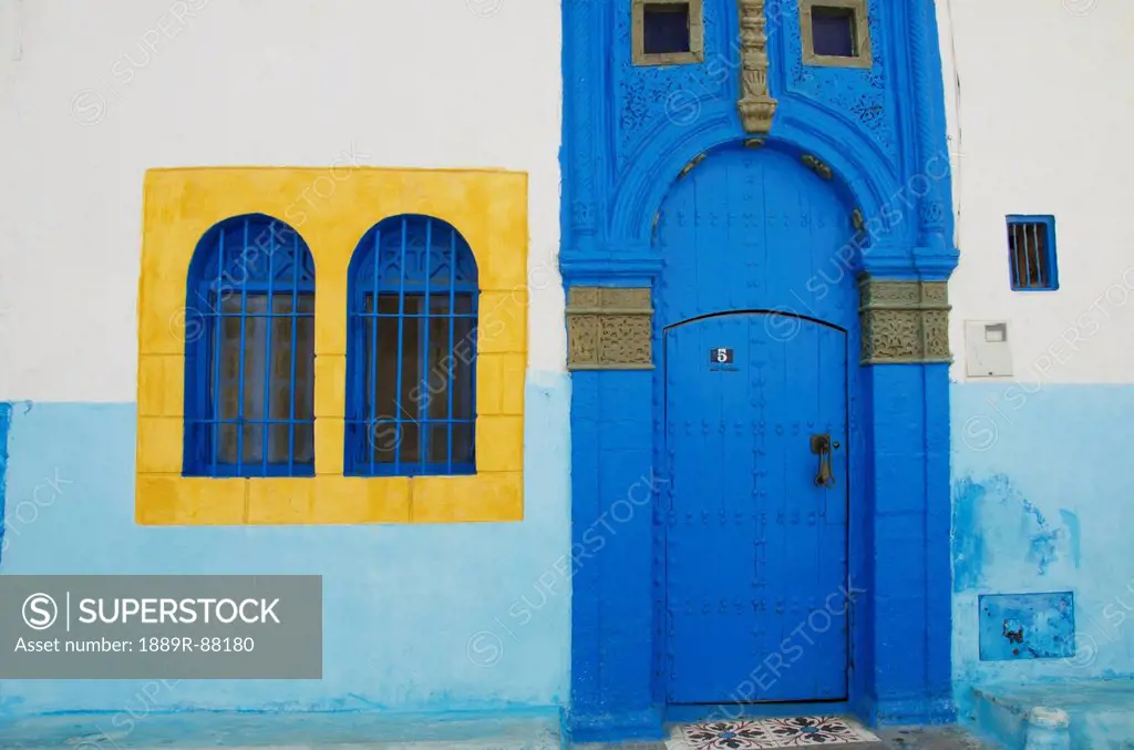 A Painted Blue Door And Bright Yellow Window Frame On A House In Old Town;Rabat Morocco