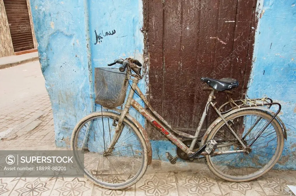 A Bicycle Leaning Against A Weathered Wall;Casablanca Morocco