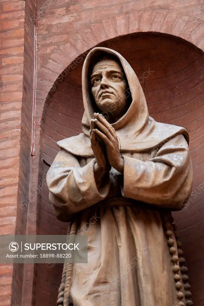 Close Up Of A Monk Statue Inside Brick Arch;Bologna Emilia-Romagna Italy