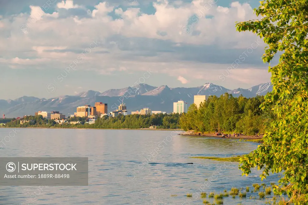The anchorage city skyline seen from the tony knowles coastal trail during high tide chugach mountains in the background;Anchorage alaska united state...