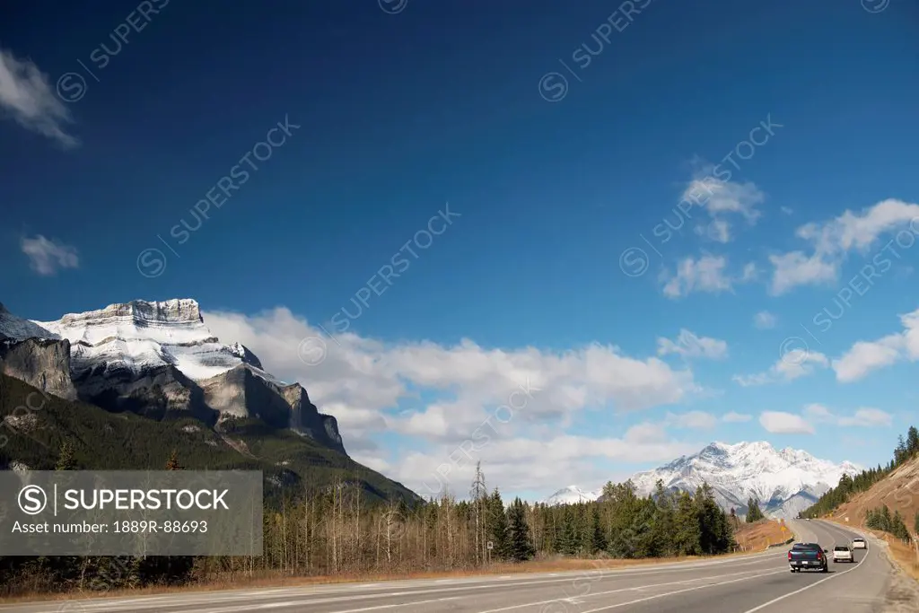 Vehicles on a highway with the canadian rocky mountains in banff national park;Alberta canada