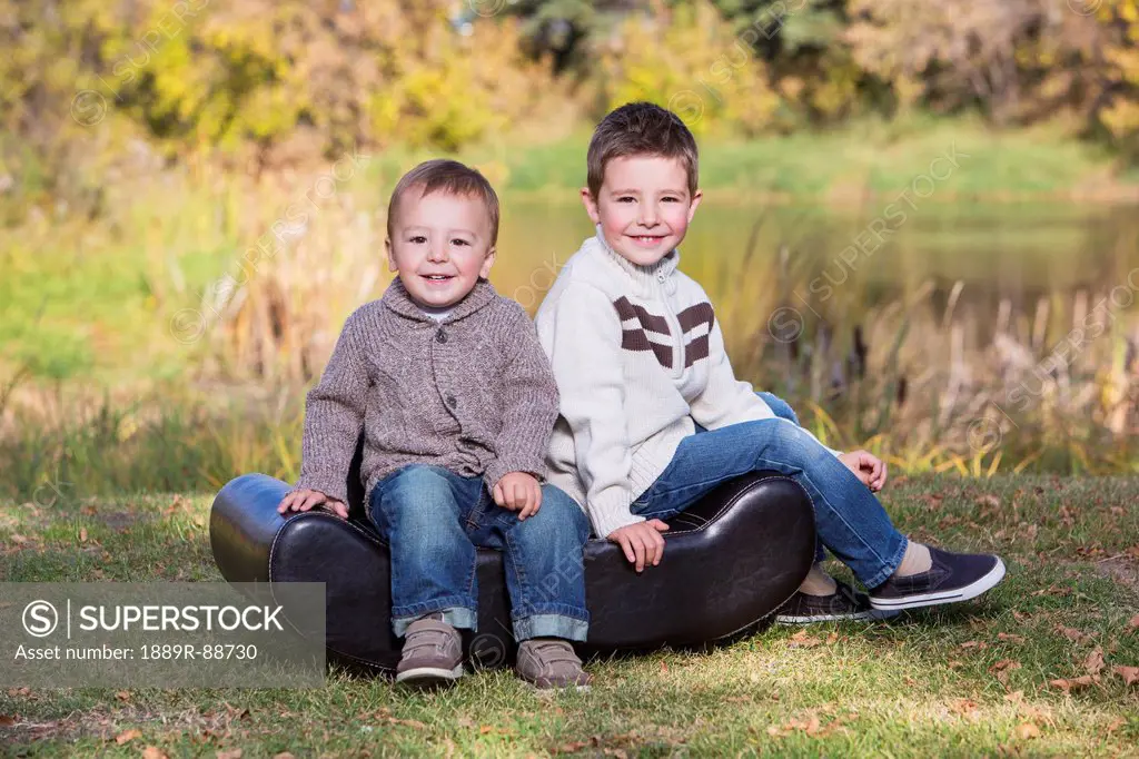 Portrait of two young boys in a park in autumn;St. albert alberta canada