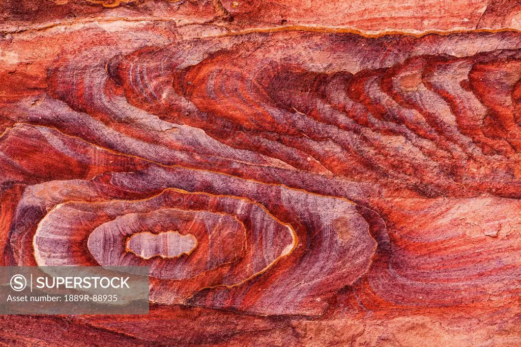 Coloured stone eroded in a design;Petra jordan