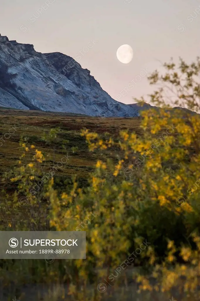 A moon in the sky and brooks range gates of the arctic national park northwestern alaska;Alaska united states of america