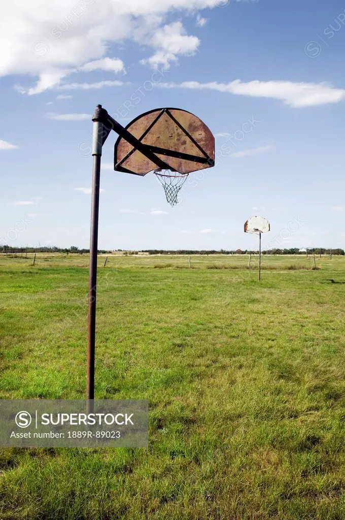Basketball nets in a grass field;Saskatchewan canada