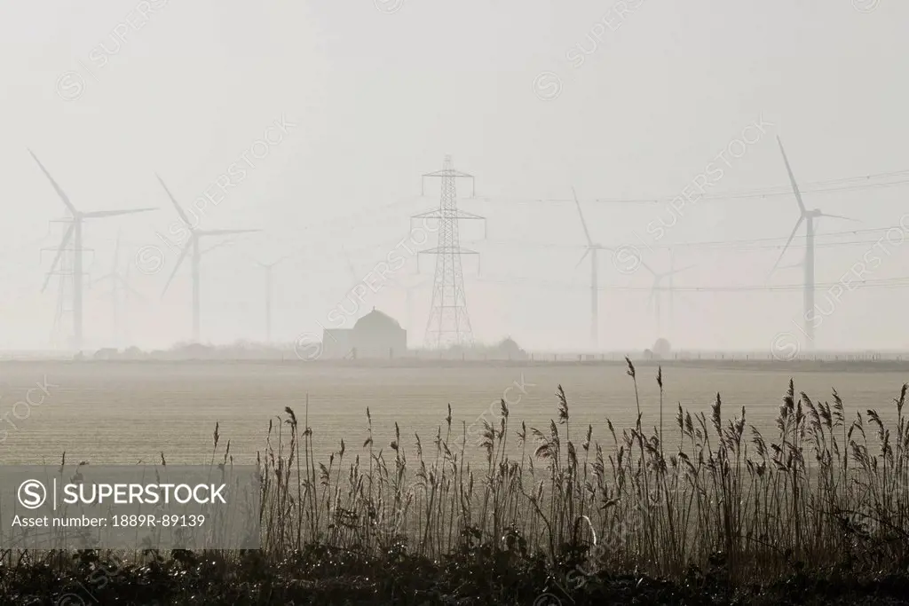 Misty morning at the little cheyne court wind farm at romney marsh;Kent east sussex england