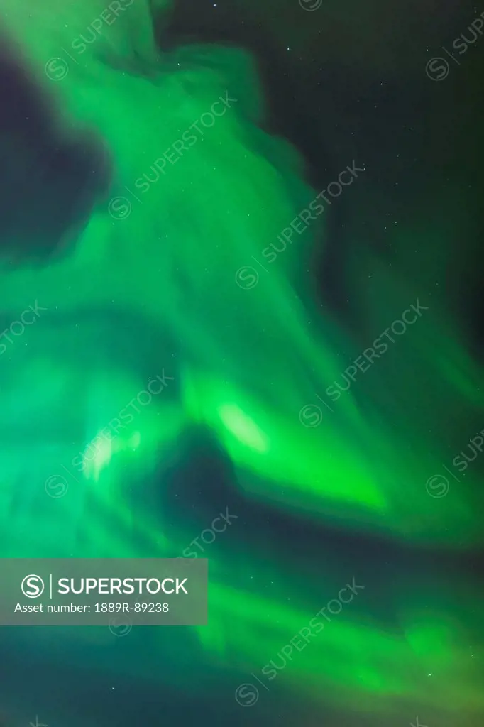 The green northern lights corona in the sky above the tony knowles coastal trail in winter at nighttime;Anchorage alaska united states of america