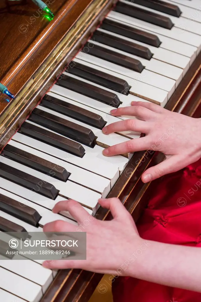 A girl's hands as she plays the piano;Anchorage alaska united states of america