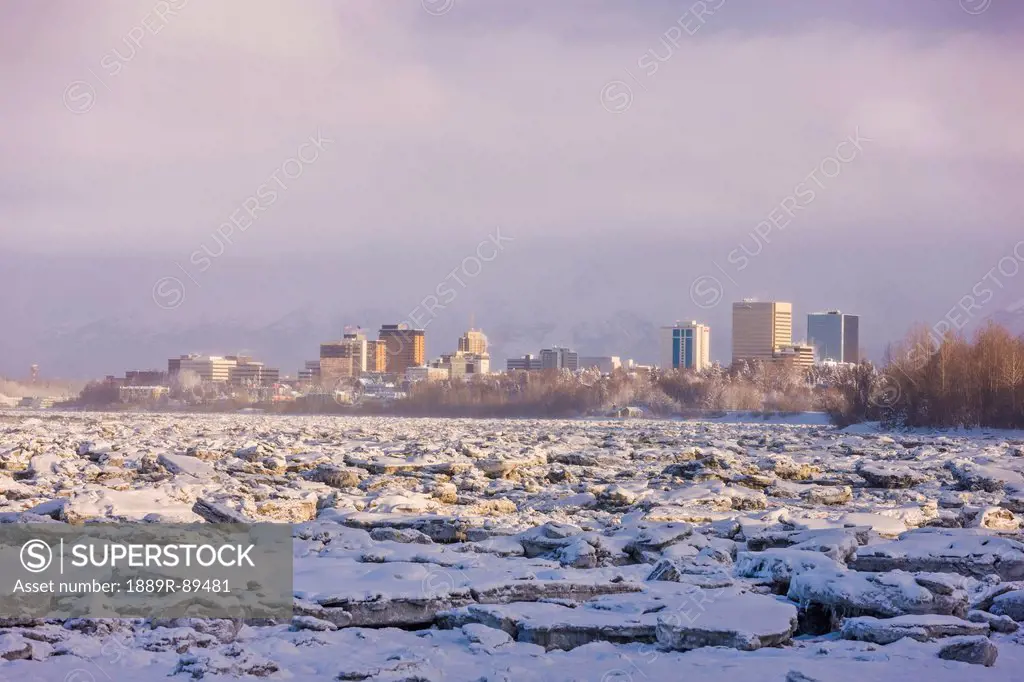 The Downtown Anchorage Skyline as seen from the Tony Knowles Coastal Trail, Frozen Knik Arm in the foreground, Winter, Anchorage, Southcentral Alaska,...