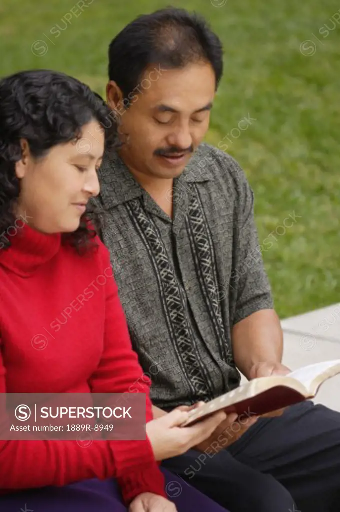 Latino couple reading the Bible