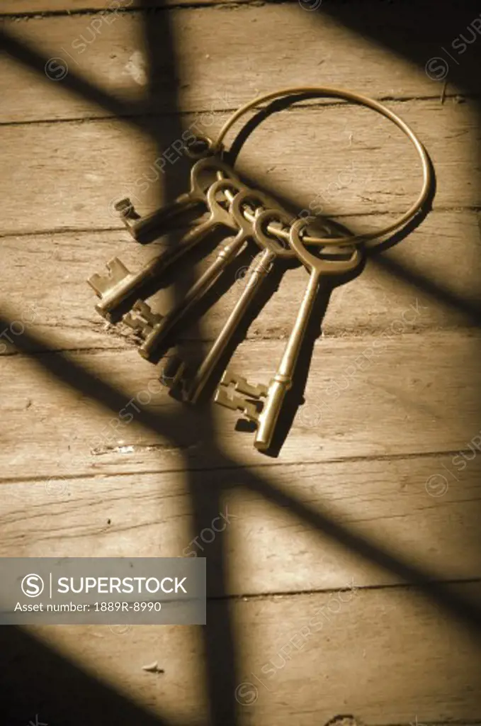 Old-fashioned keys on wood floor