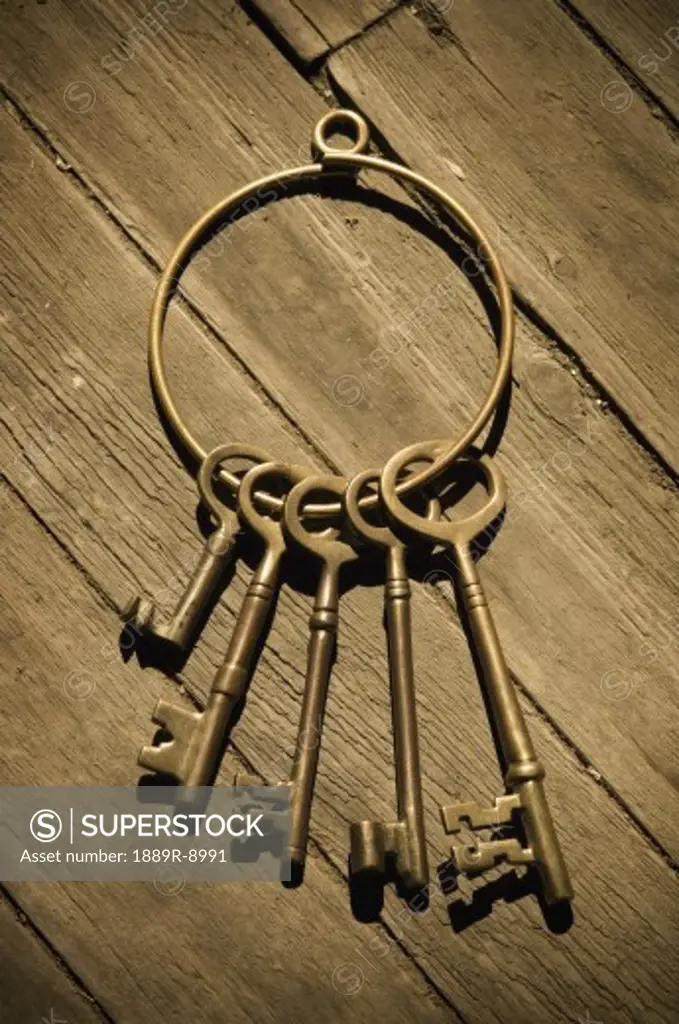 Old-fashioned skeleton keys laying on distressed wood floor