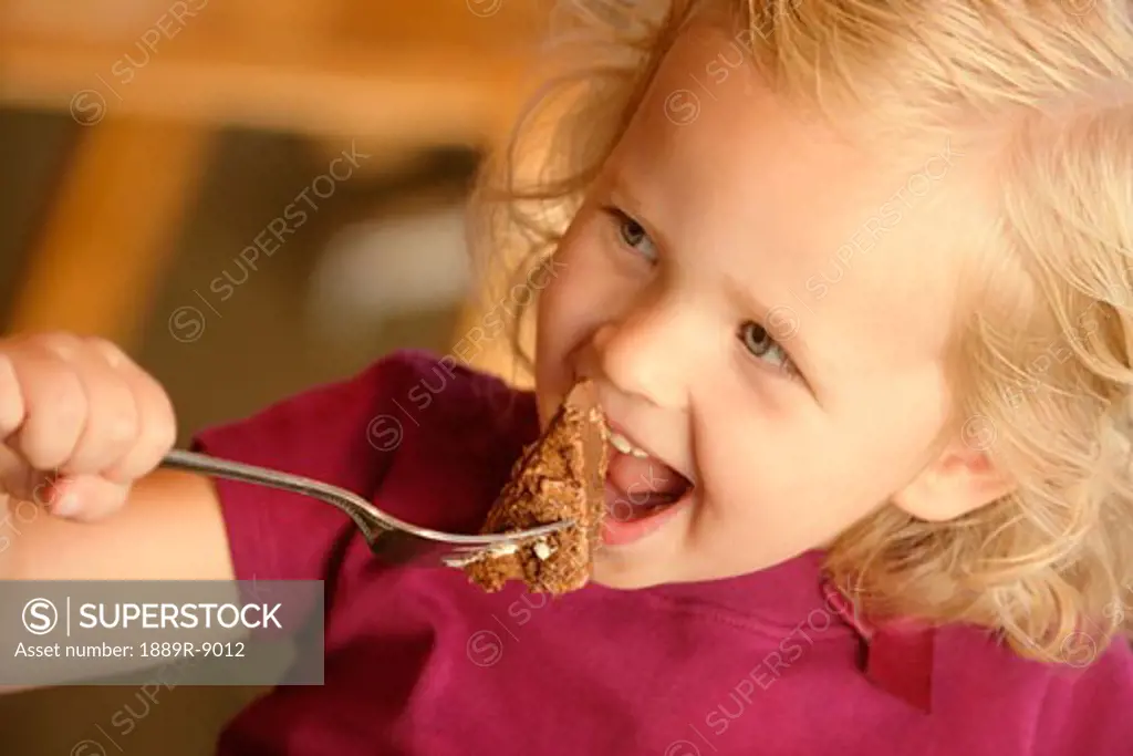 Little girl eating cake