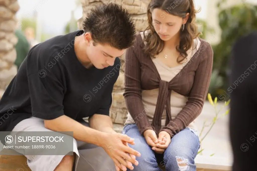 Two teens praying together