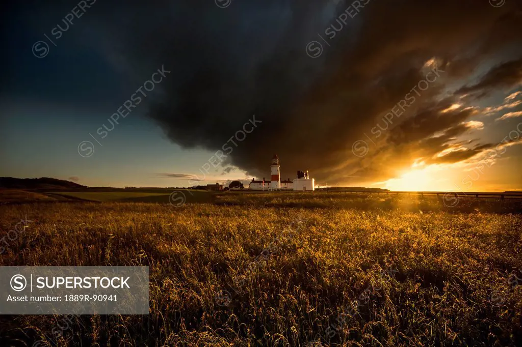 A dark cloud formation above a field at sunset;South shields tyne and wear england