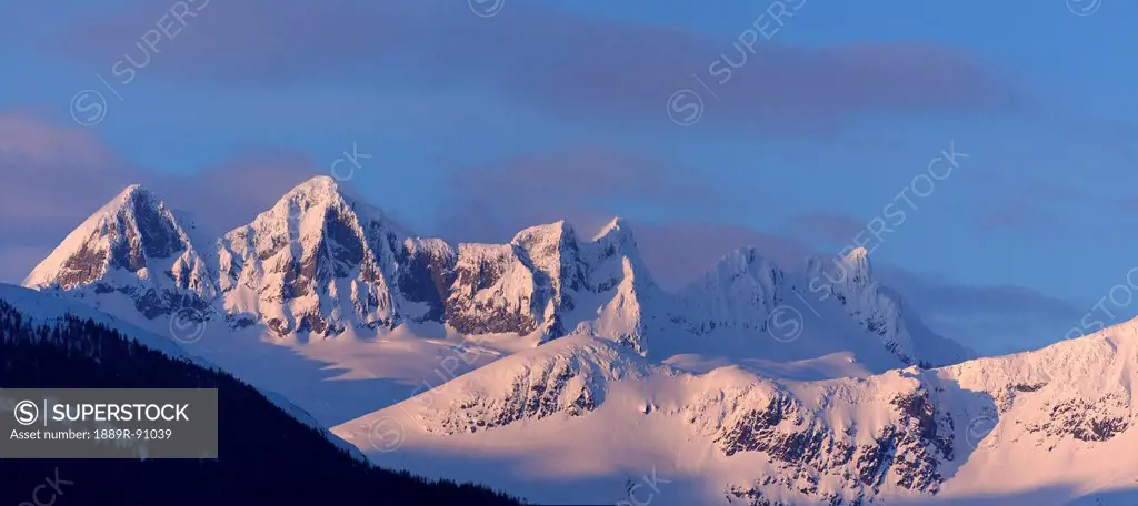 Alpenglow colours the landscape around mendenhall glacier and mendenhall towers in the evening;Juneau alaska united states of america