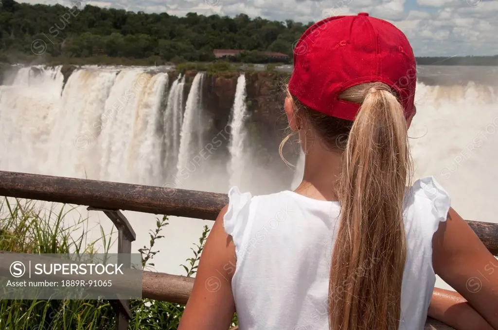 Girl watching iguazu falls from outlook point;Argentina