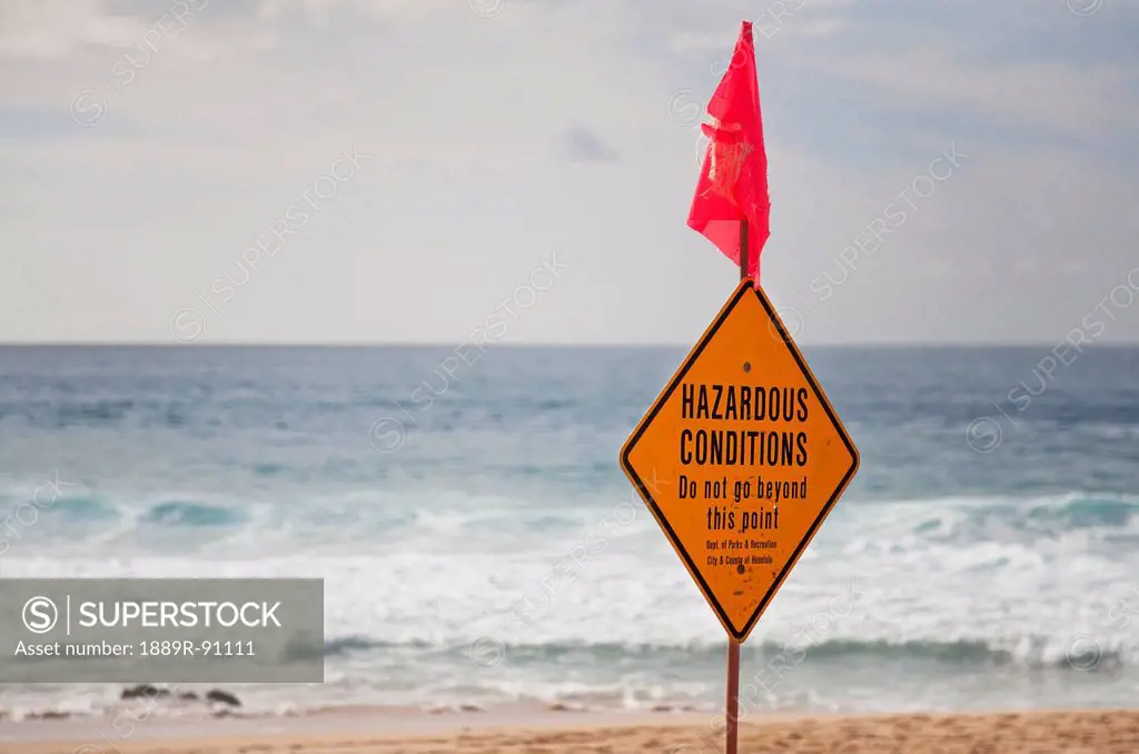 A sign on the beach for hazardous conditions;Honolulu oahu hawaii united states of america