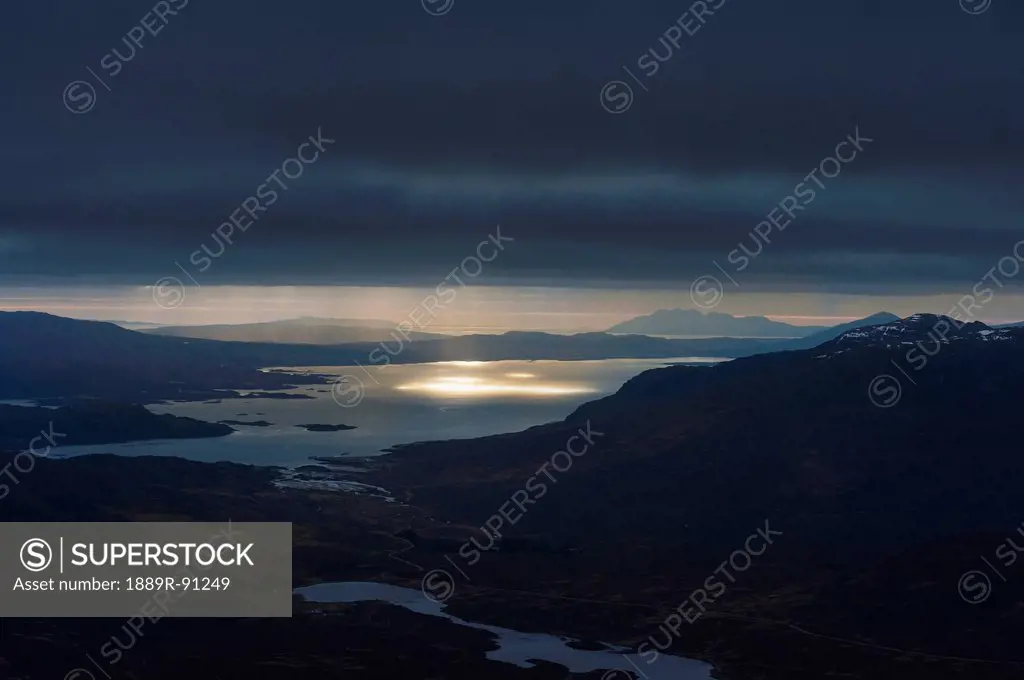 Crepuscular rays (beams of sunlight) coming through clouds as seen from near the summit of ben damph;Torridon highlands scotland