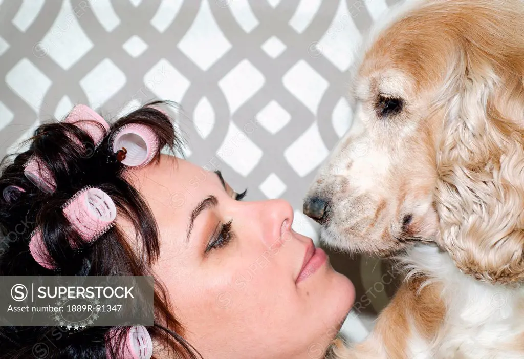 Portrait of a woman wearing hair rollers and her dog;Lacarno ticino switzerland