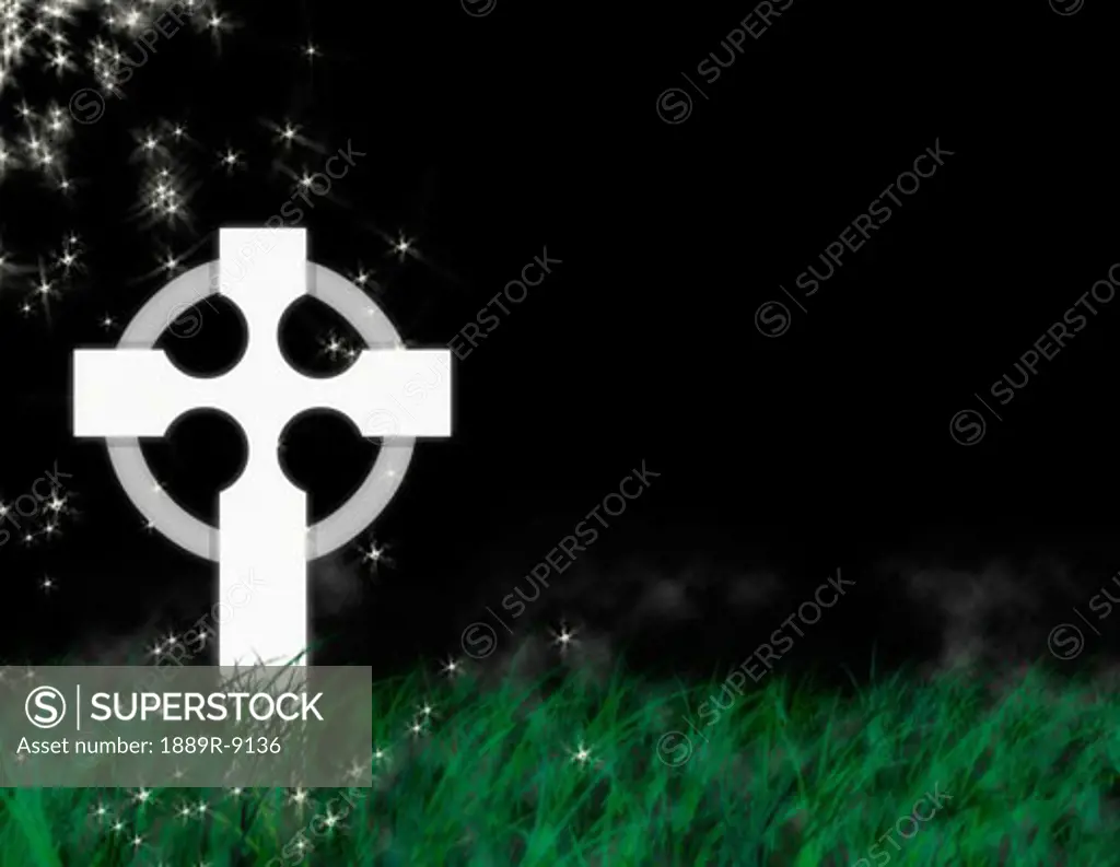 Cross tombstone in tall grass