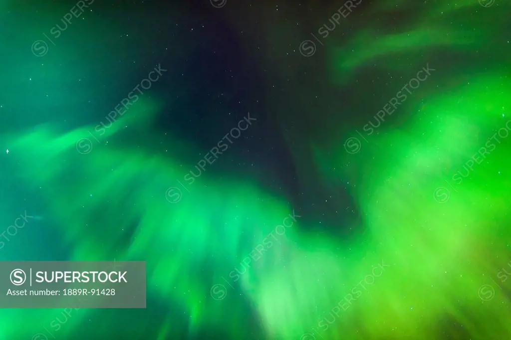 A Green Northern Lights Corona in the sky above the Tony Knowles Coastal Trail in winter; Anchorage, Alaska, United States of America