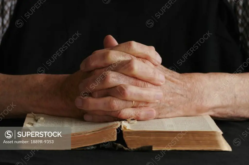 Closeup of senior's hands on Bible