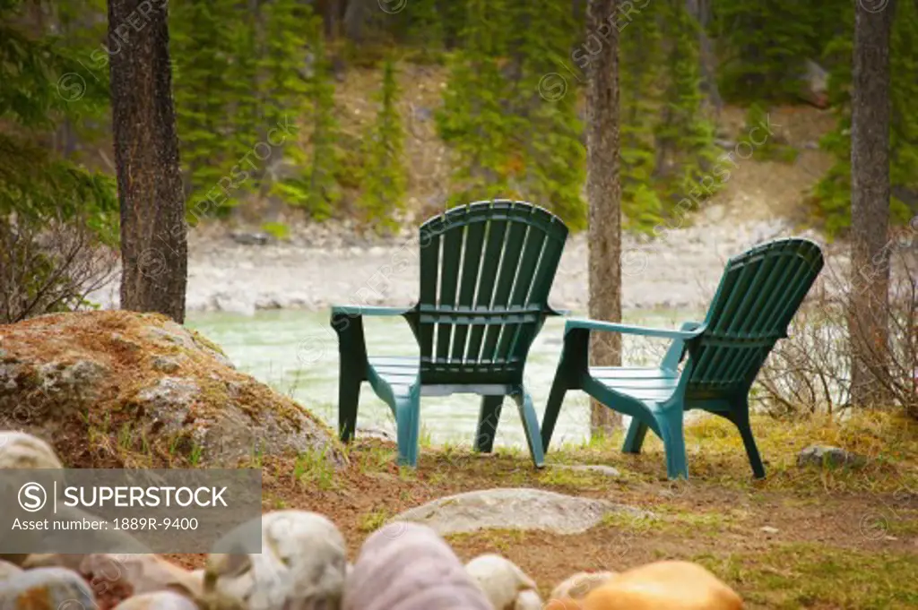 Lawn chairs situated by the lake
