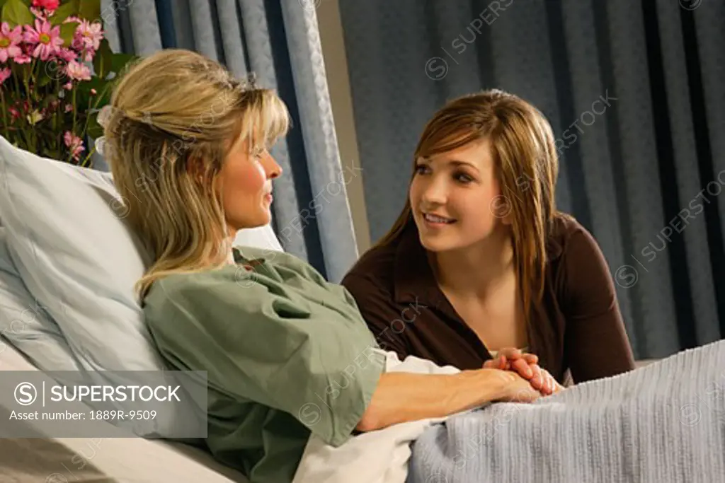Girl supporting woman in hospital
