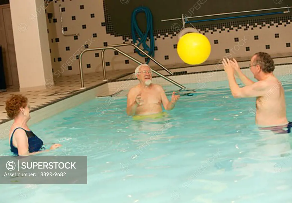 Seniors playing ball in a pool