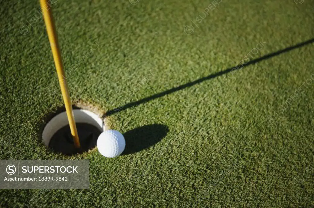 Golf ball close to pin