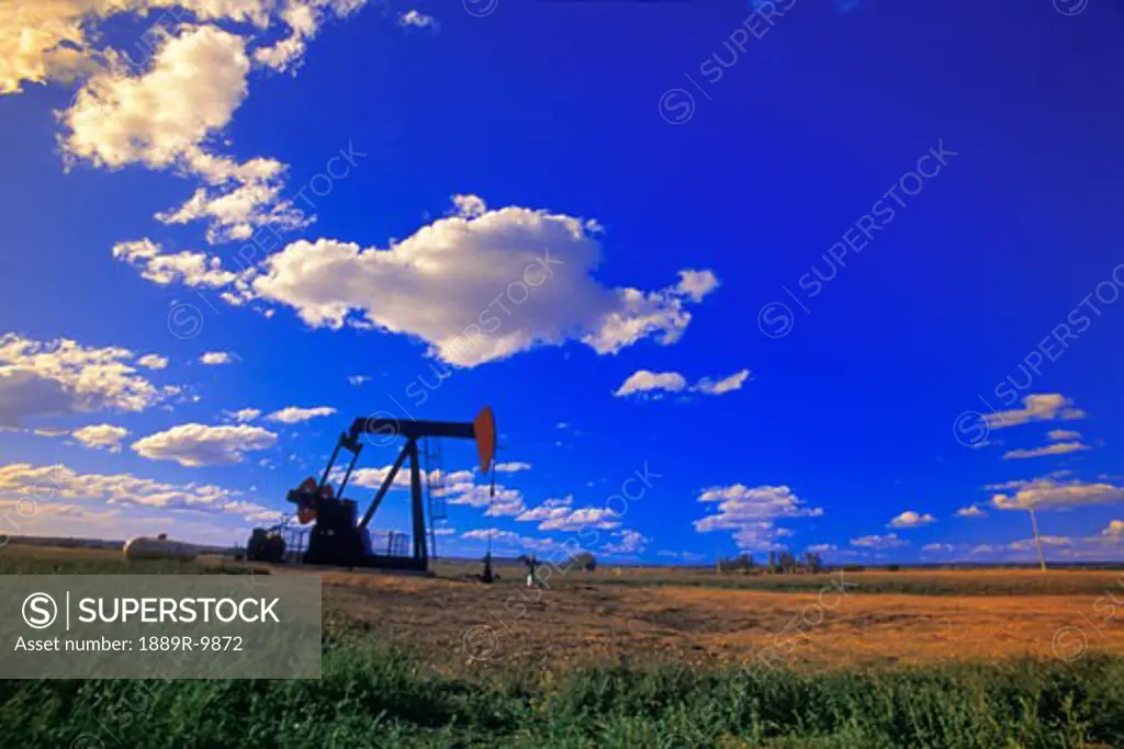 An oil derrick in a field