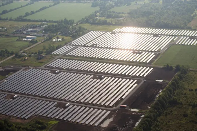 Aerial view of a solar farm reflecting the sun off the panels; Port Colborne, Ontario, Canada