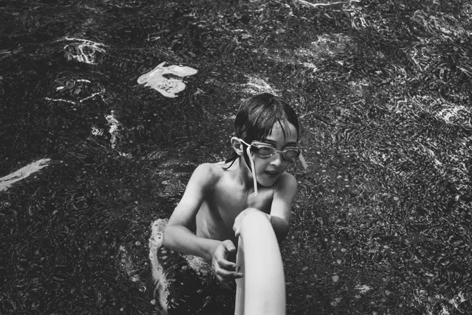 Boy With Swimming Goggles In Pool; Otterburn Park Quebec Canada