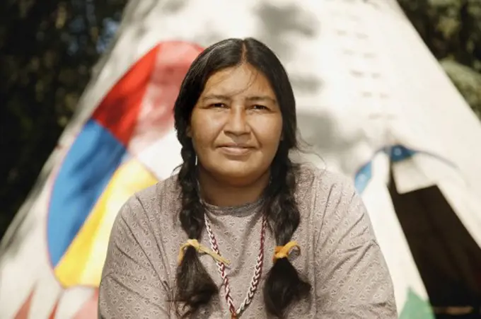 Woman sitting in front of a Tipi