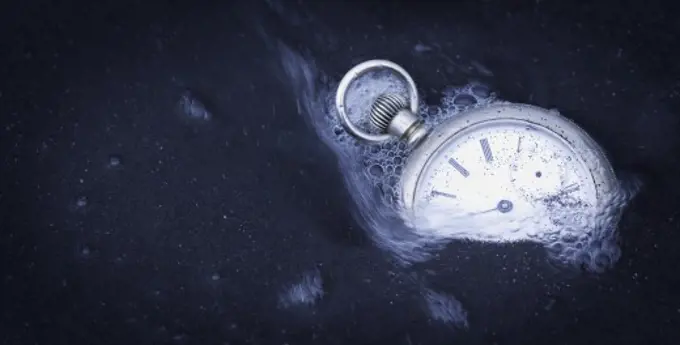 Watch being swept away by water as it is surrounded by sand