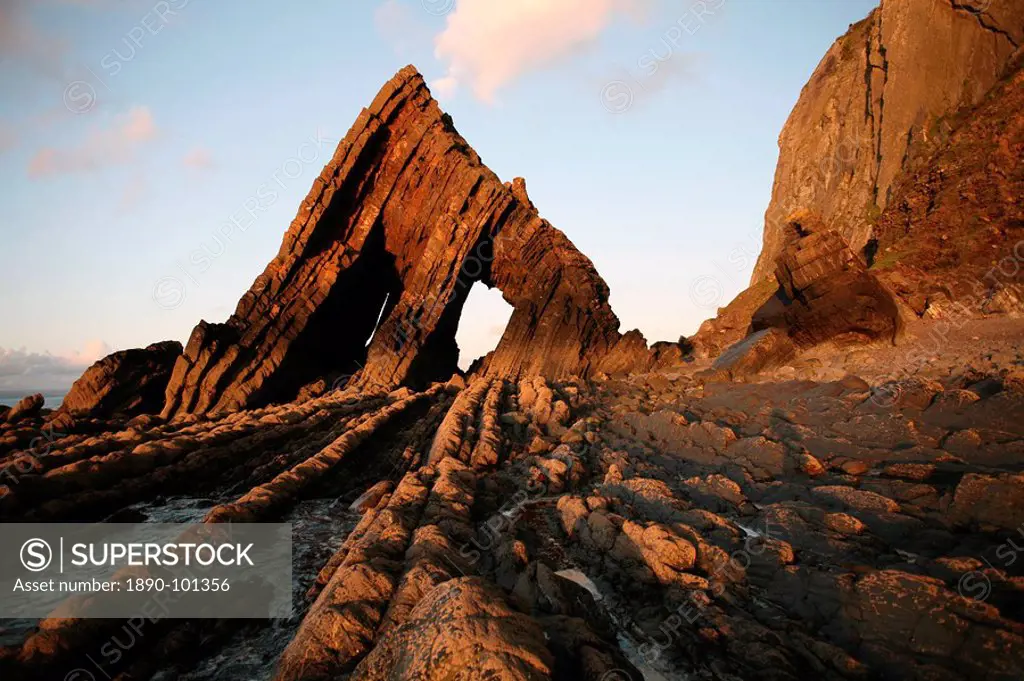 The light of the setting sun illuminates the unusual architecture of Blackchurch Rock, which lies under cliffs between Clovelly and Hartland Point, Cu...