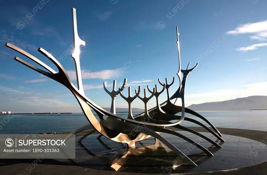The midnight sun lights up the giant steel boat sculpture that stands on the water´s edge at Reykjavik, Iceland, Polar Regions