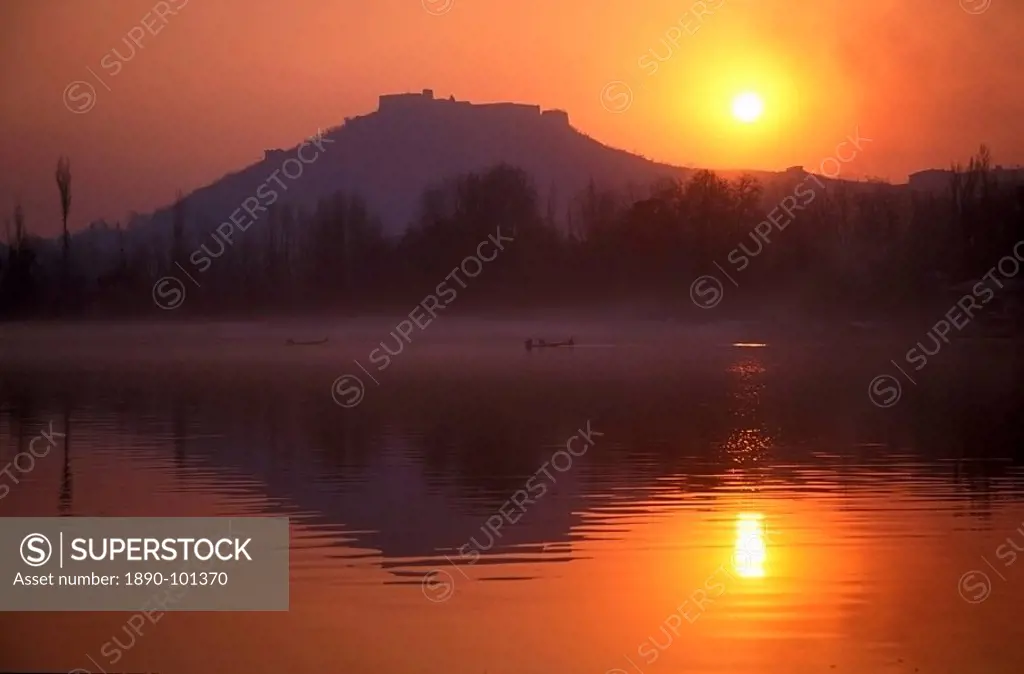 Fishermen make their way home in canoes as the sun sets over Nigeen Lake, Srinagar, capital of Indian_administered Kashmir, India, Asia