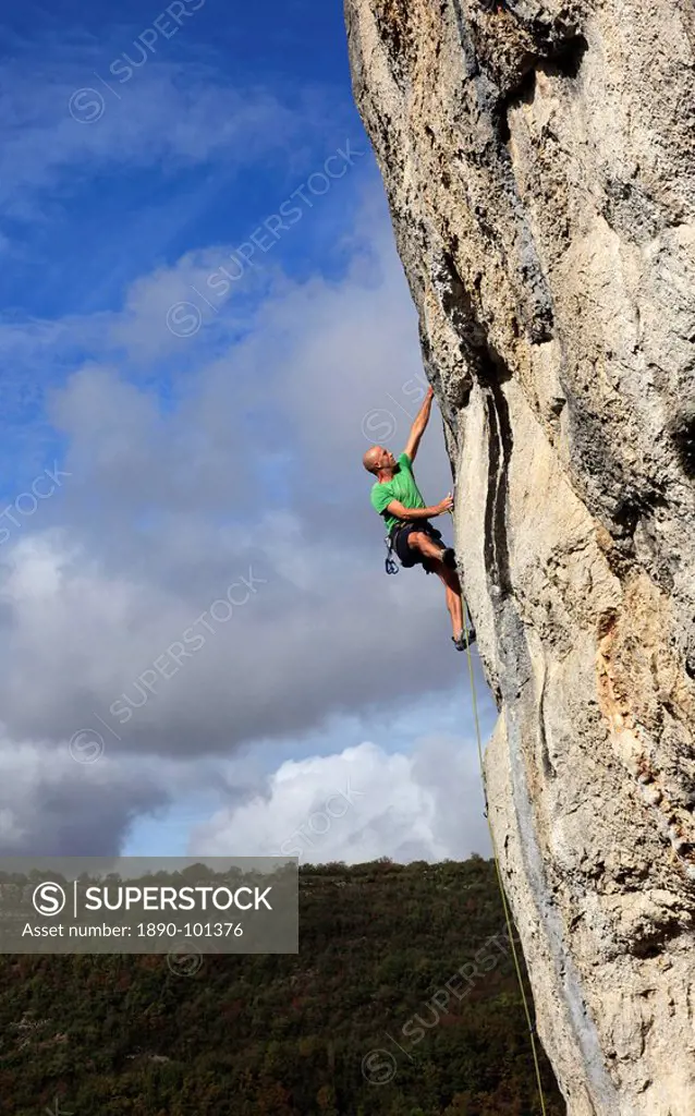A climber tackles a very difficult rock climb in the Gorge d´Aveyron, near St. Antonin and Gaillac, Massif Central, France