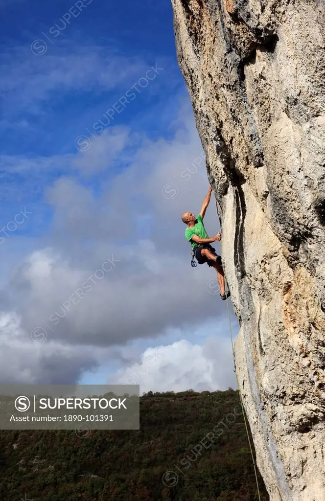 A climber tackles a steep and challenging route on the cliffs of the Aveyron Gorge, Aveyron region, Massif Central, France