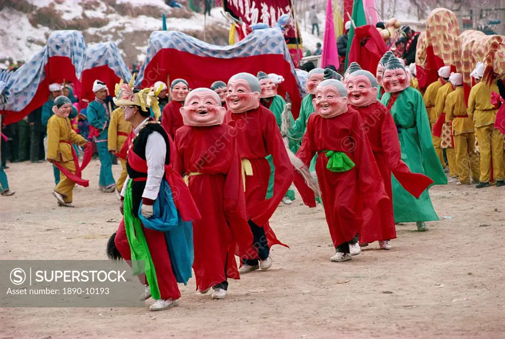 Crowds of costumed dancers celebrate Chinese New Year, Xining, Qinghai Province, China, Asia