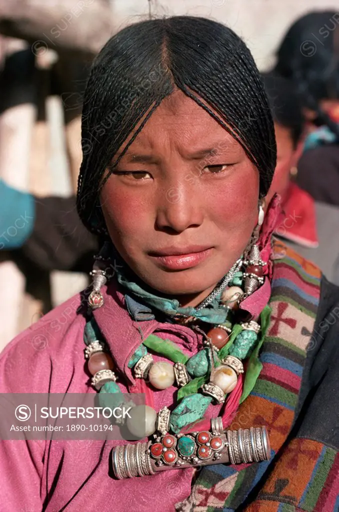 Portrait of a Tibetan nomad woman with turquoise and silver jewellery, at Tongren, Qinghai, China, Asia