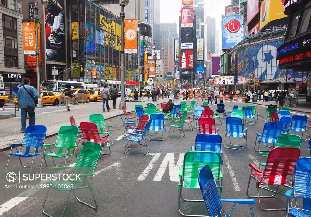 Garden chairs in the road for the public to sit in the pedestrian zone of Times Square, New York City, New York, United States of America, North Ameri...