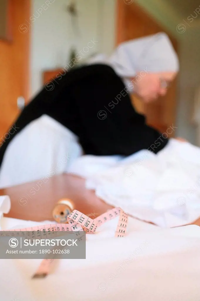 Benedictine nun making religious vestment, Urt, Pyrenees Atlantique, France, Europe