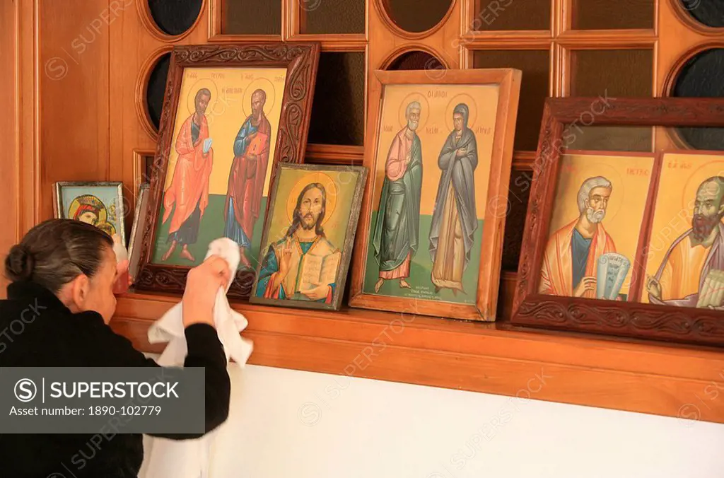 Greek Orthodox woman cleaning icons, Thessaloniki, Macedonia, Greece, Europe